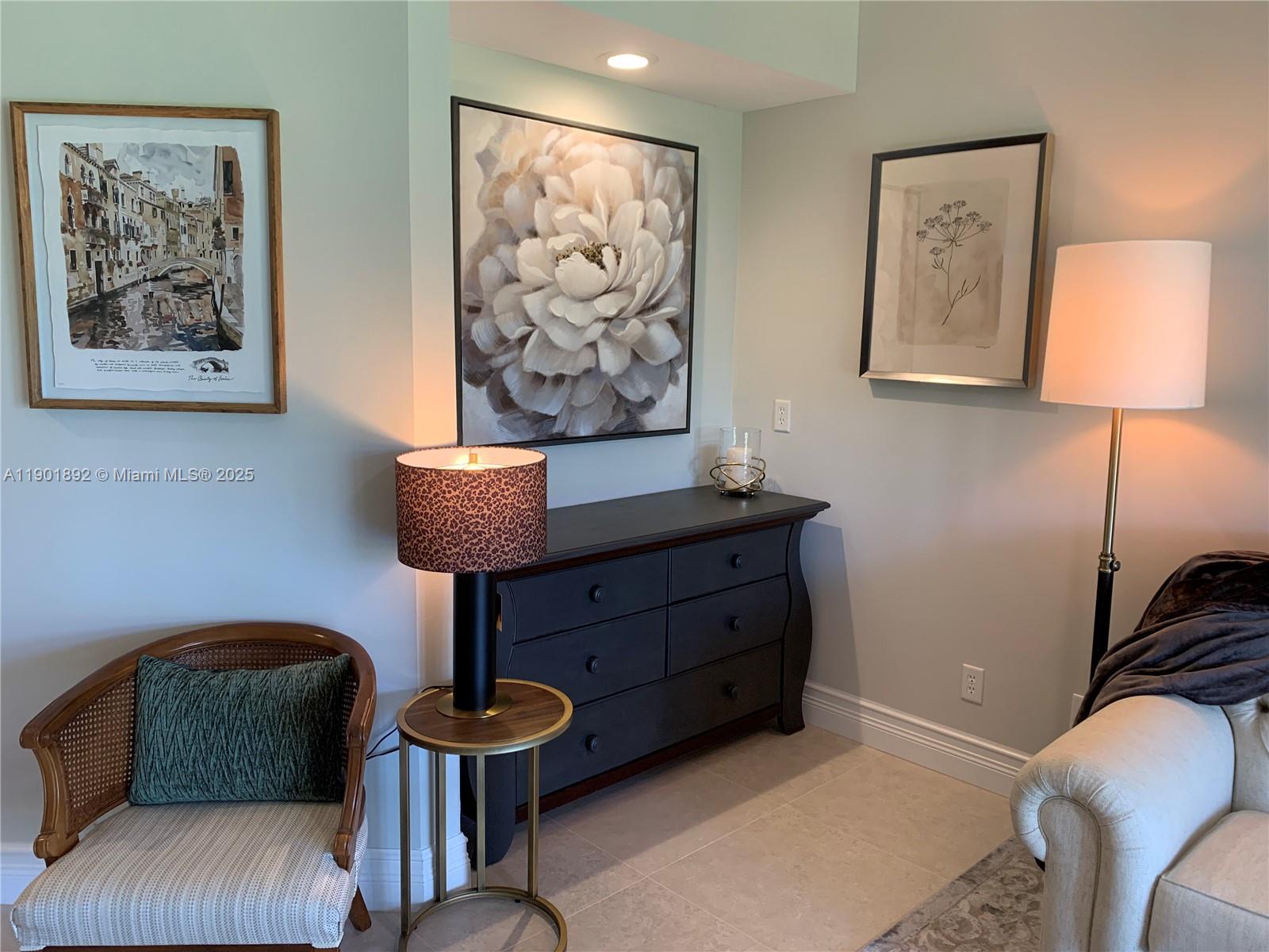 6102 Southeast Landing Way, Unit 2 Stuart, FL 34997 - Photo 24 of 51 a living room with furniture and a lamp