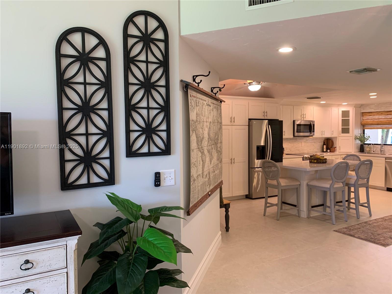 6102 Southeast Landing Way, Unit 2 Stuart, FL 34997 - Photo 29 of 51 a living room with furniture a window and a potted plant