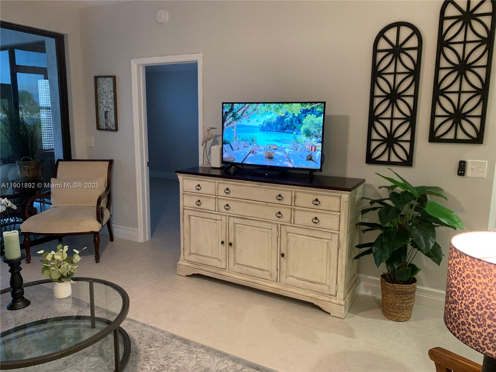 6102 Southeast Landing Way, Unit 2 Stuart, FL 34997 - Photo 30 of 51 a living room with furniture and a flat screen tv