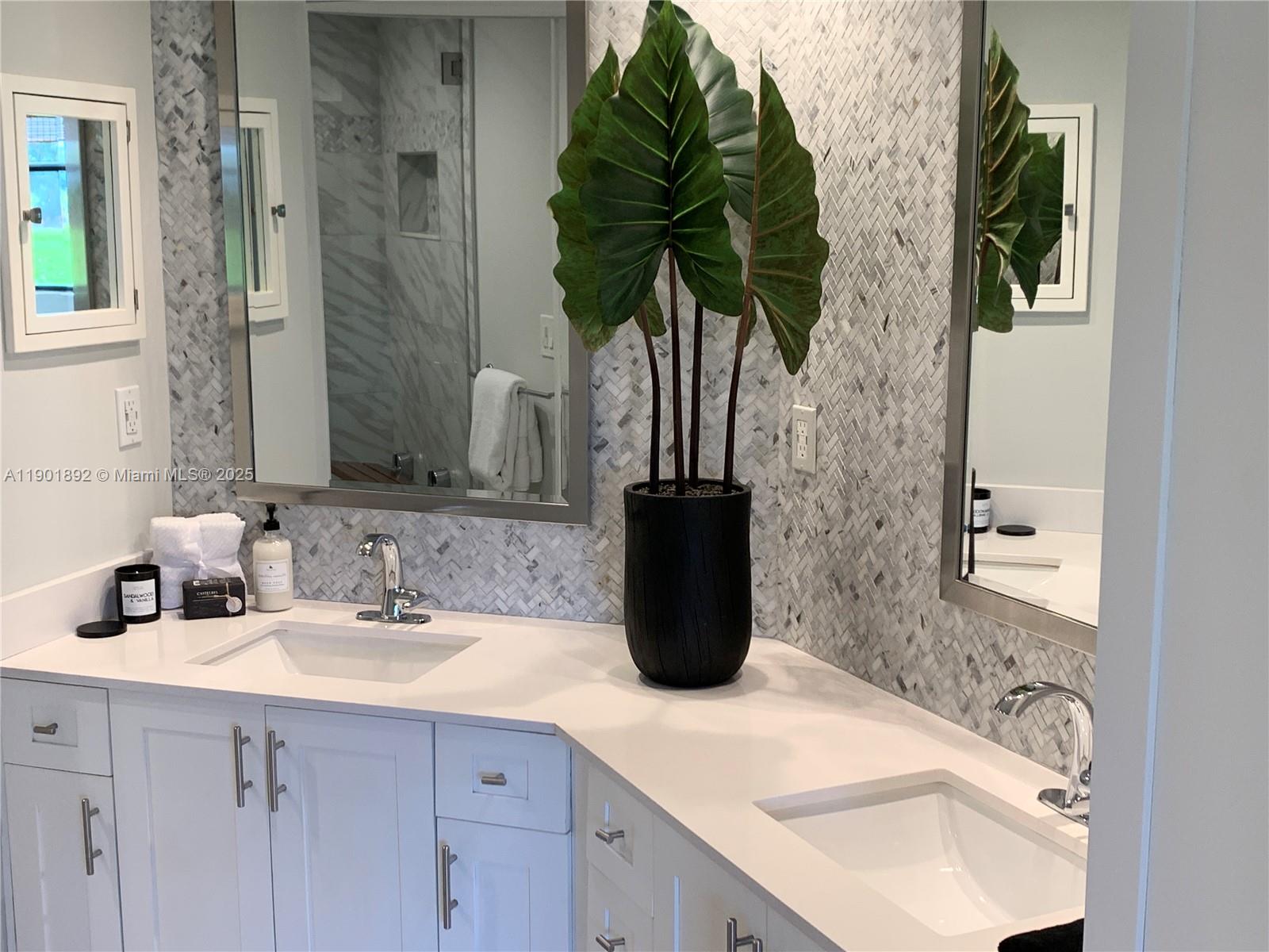 6102 Southeast Landing Way, Unit 2 Stuart, FL 34997 - Photo 32 of 51 a bathroom with a sink a vanity and a mirror