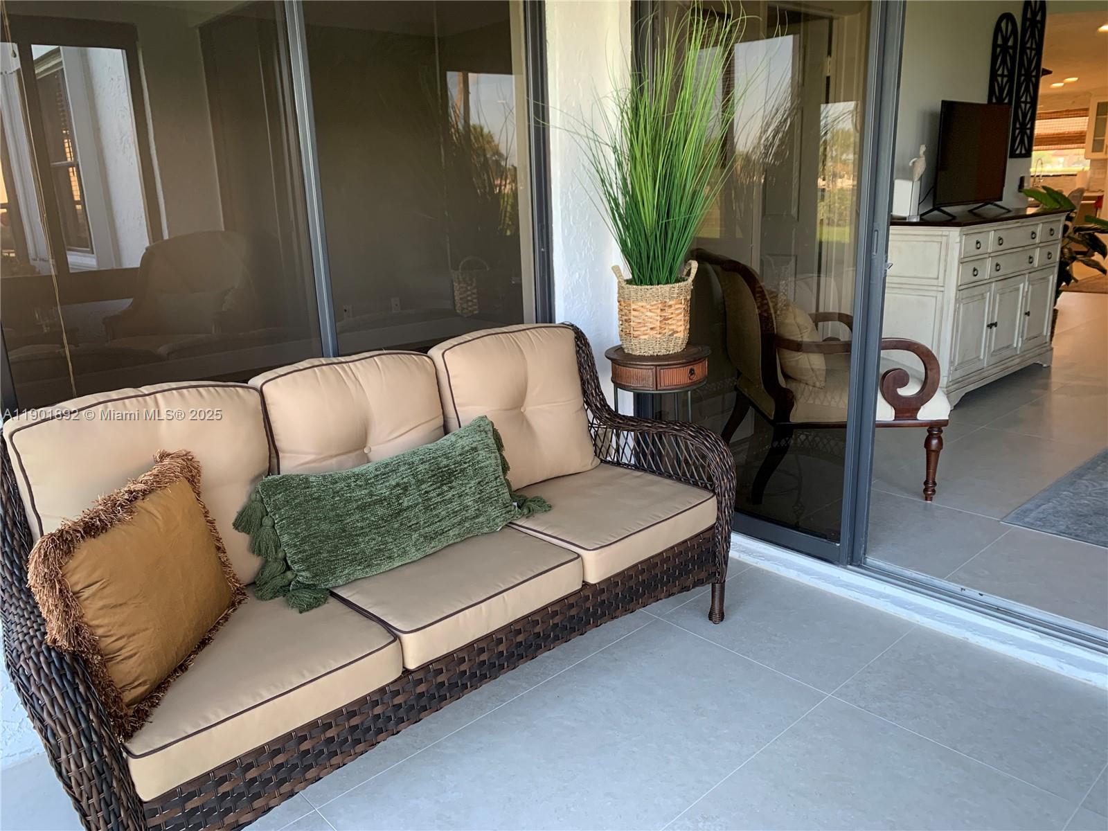 6102 Southeast Landing Way, Unit 2 Stuart, FL 34997 - Photo 39 of 51 a living room with furniture and a flat screen tv