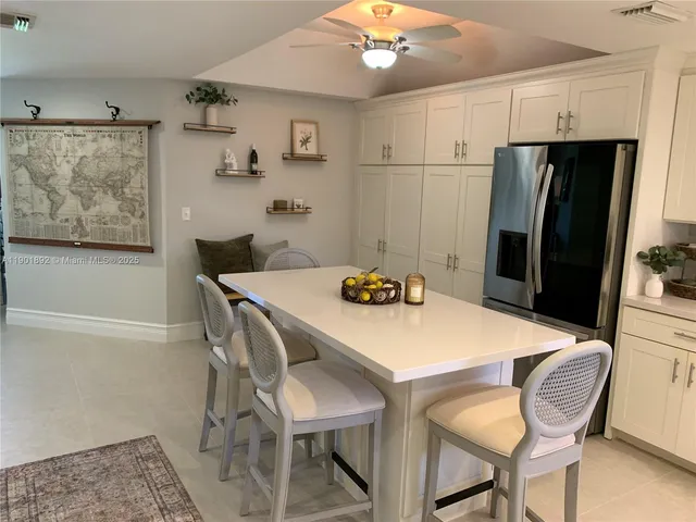 a kitchen with stainless steel appliances a refrigerator and microwave