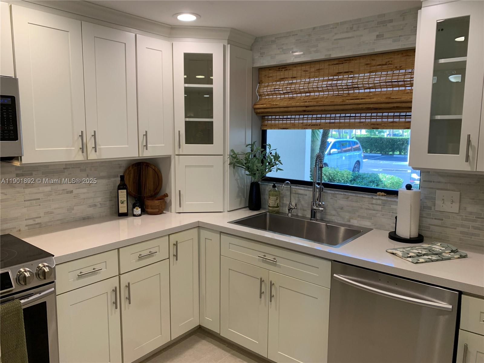 6102 Southeast Landing Way, Unit 2 Stuart, FL 34997 - Photo 7 of 51 a kitchen with a sink and cabinets