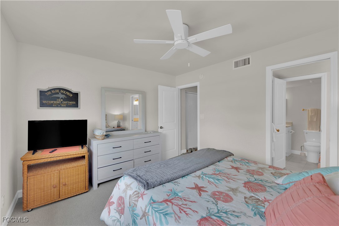 200 Lenell Road, Unit 218 Fort Myers Beach, FL 33931 - Photo 9 of 17 a bedroom with a bed and a flat screen tv