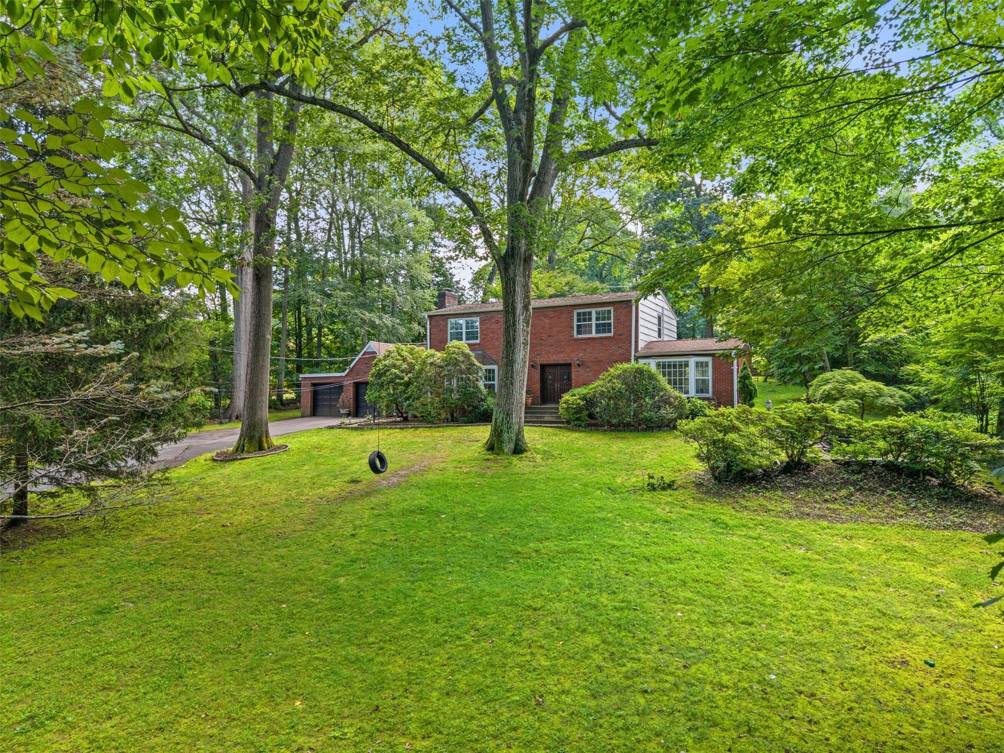 62 Sprain Valley Road Scarsdale, NY 10583 - Photo 1 of 1 a front view of a house with garden