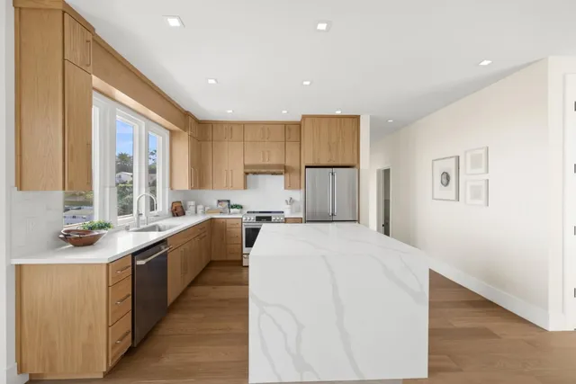 a kitchen with a sink stove and cabinets
