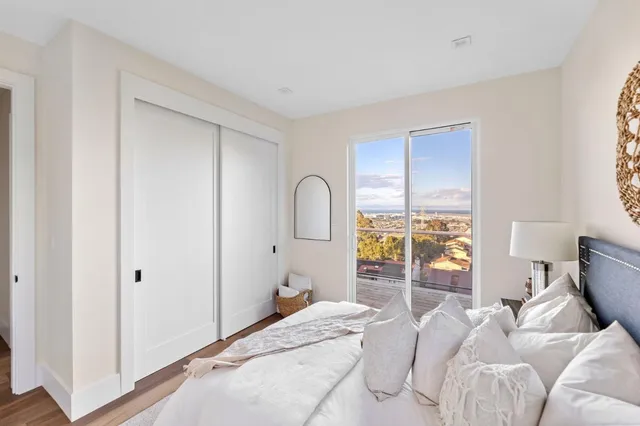 a bedroom with a bed and a large window