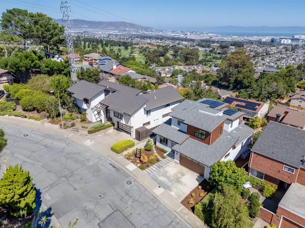 an aerial view of a house with a street