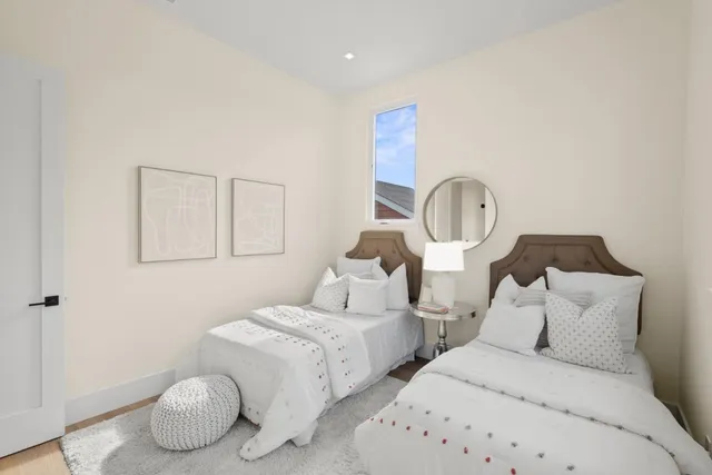 a bed room with two twin beds and a painting on the wall