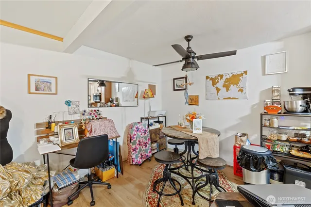 a workspace room with furniture and wooden floor