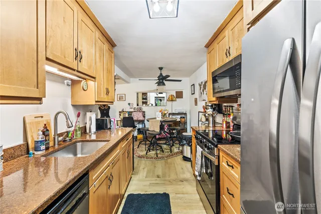 a kitchen with stainless steel appliances granite countertop lots of counter top space