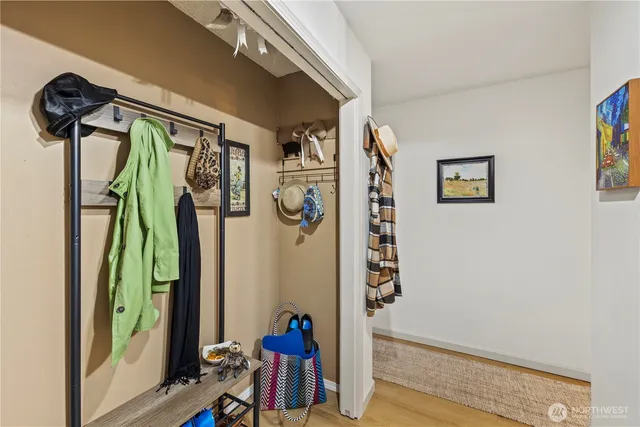 a view of walk in closet with clothes and shoes