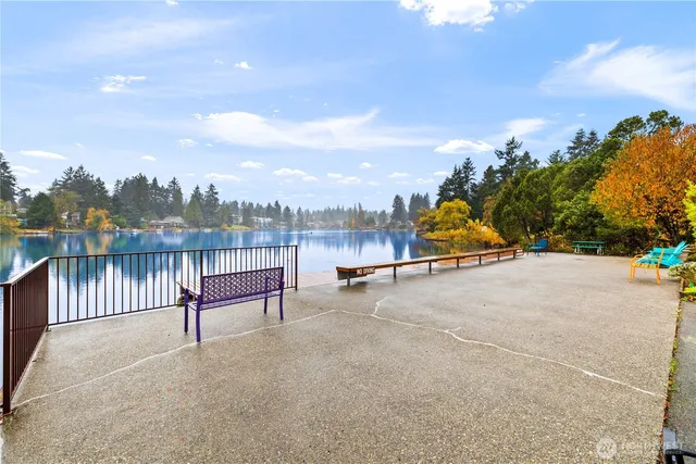a view of a lake with a bench next to a lake