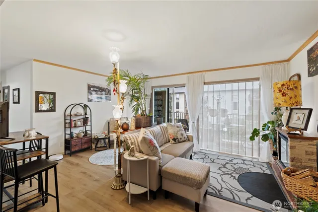 a living room with furniture chandelier and a flat screen tv
