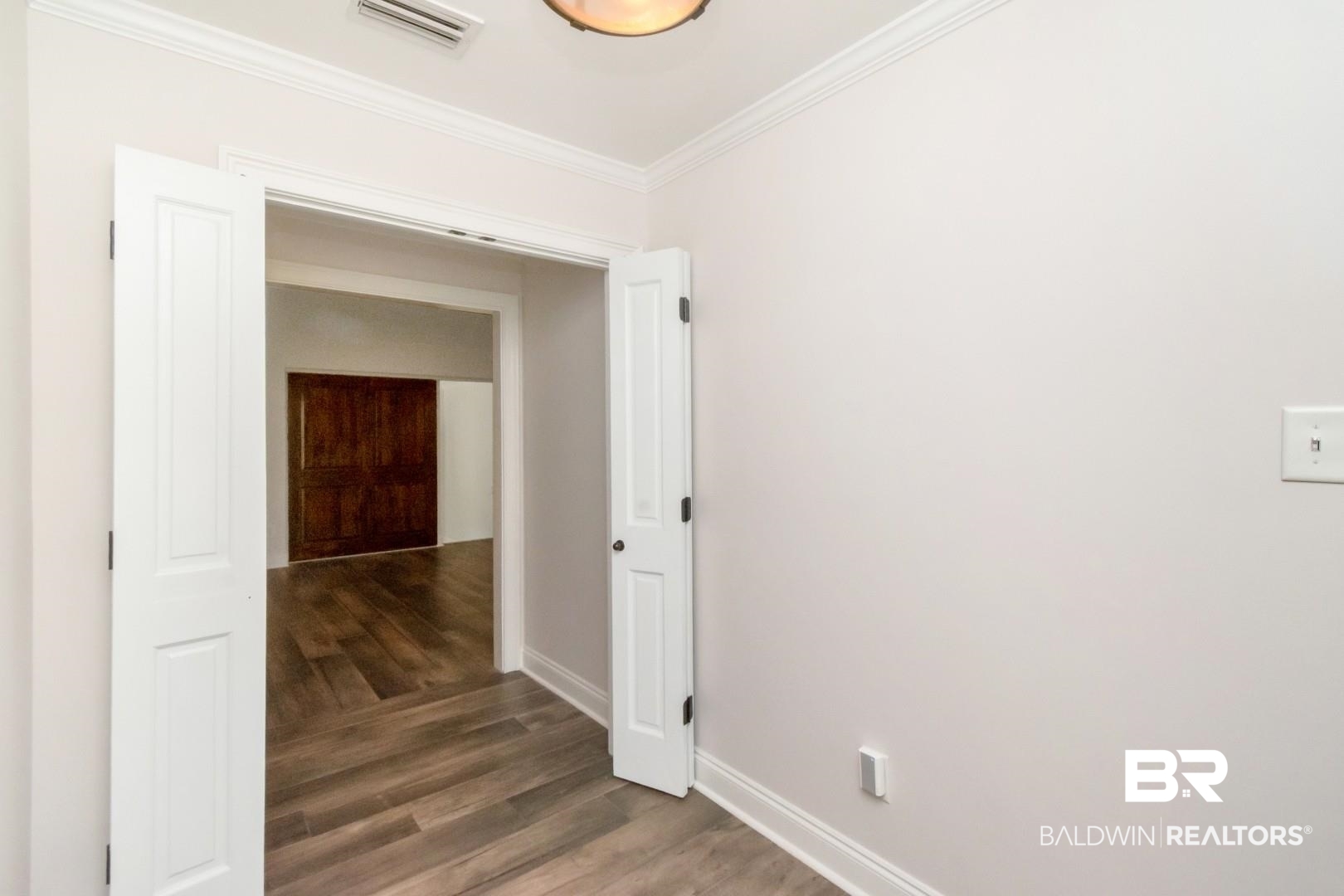 231 Rochester Road Mobile, AL 36608 - Photo 4 of 51 Hallway with crown molding and dark wood finished floors