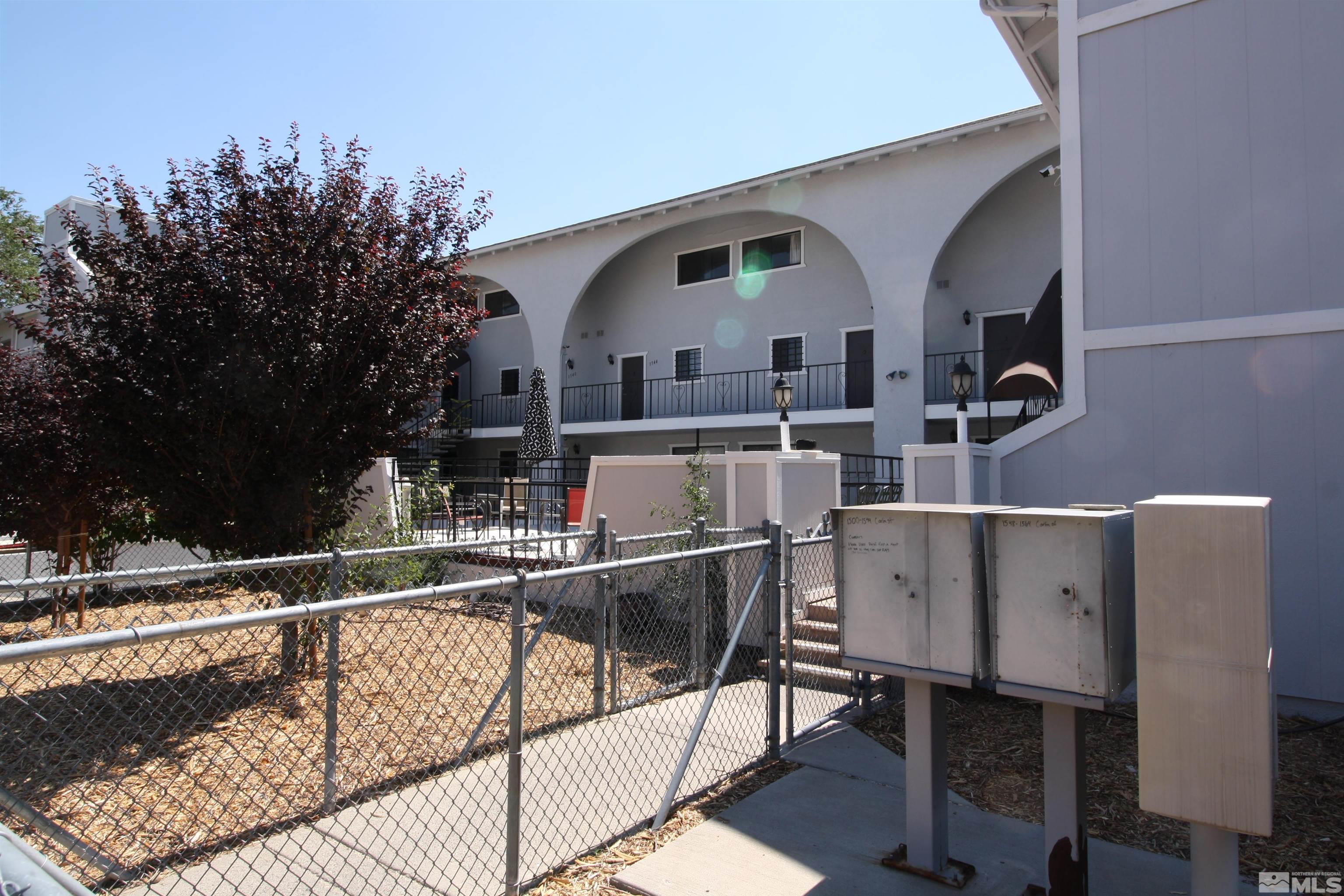 1540 Carlin Street, Unit BLD #1 Reno, NV 89503 - Photo 3 of 11 a view of a balcony with chairs and iron fence