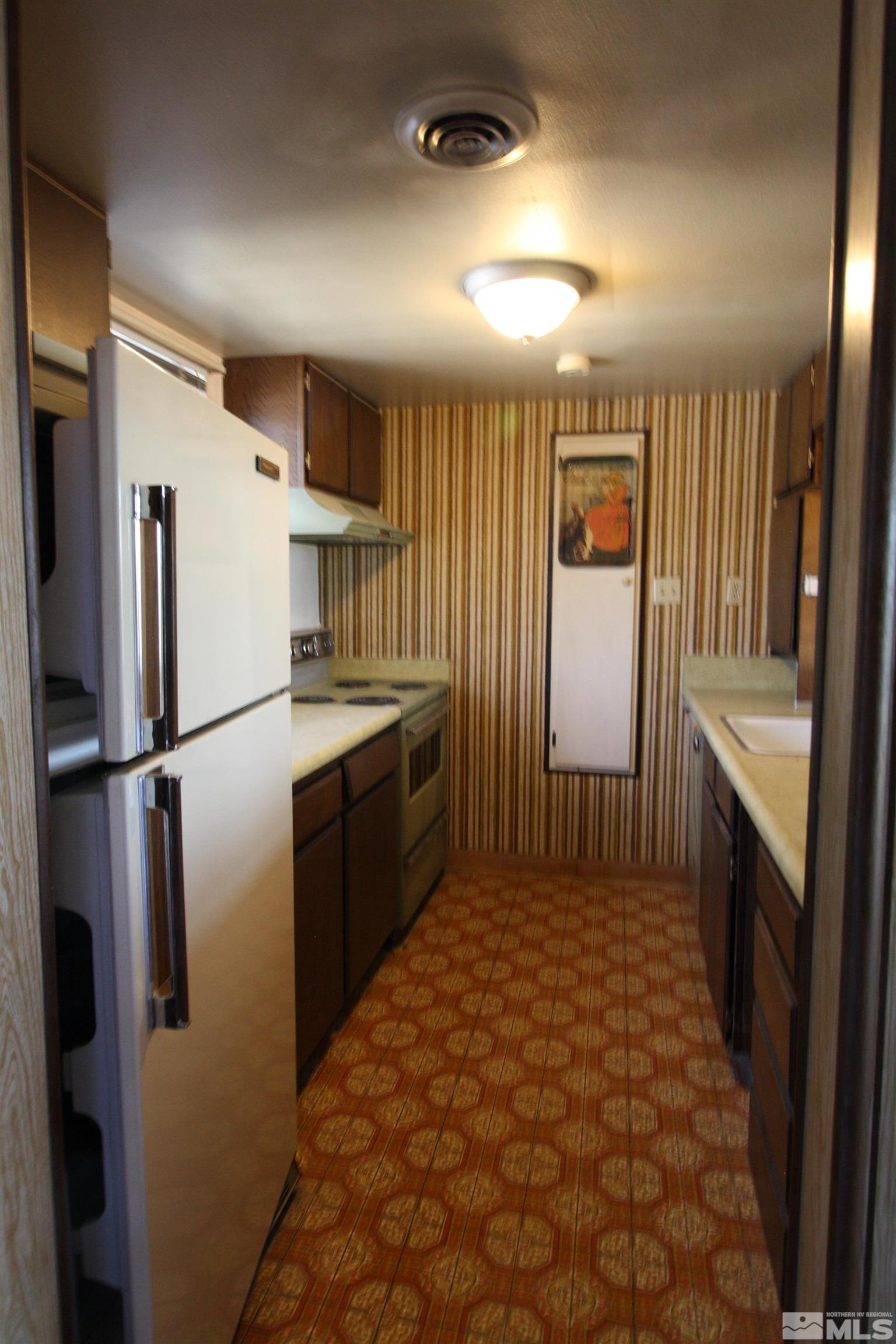 1540 Carlin Street, Unit BLD #1 Reno, NV 89503 - Photo 6 of 11 a kitchen with stainless steel appliances a refrigerator and a stove