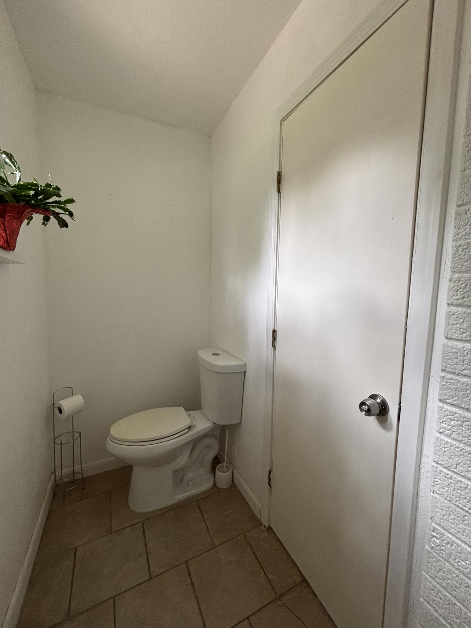 2313 47th Street Lubbock, TX 79412 - Photo 13 of 17 a white toilet sitting next to a shower