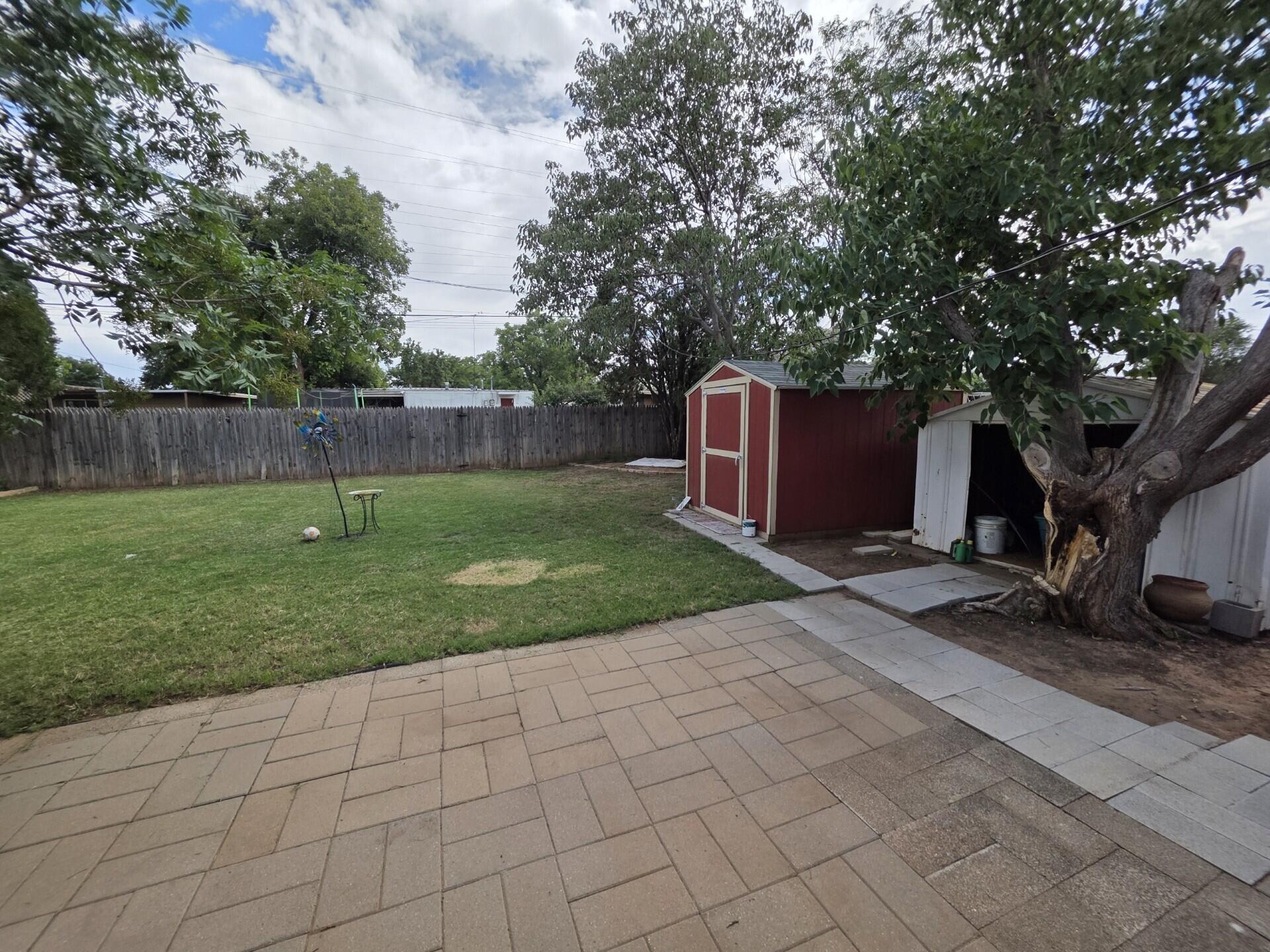 2313 47th Street Lubbock, TX 79412 - Photo 14 of 17 a backyard of a house with lots of green space