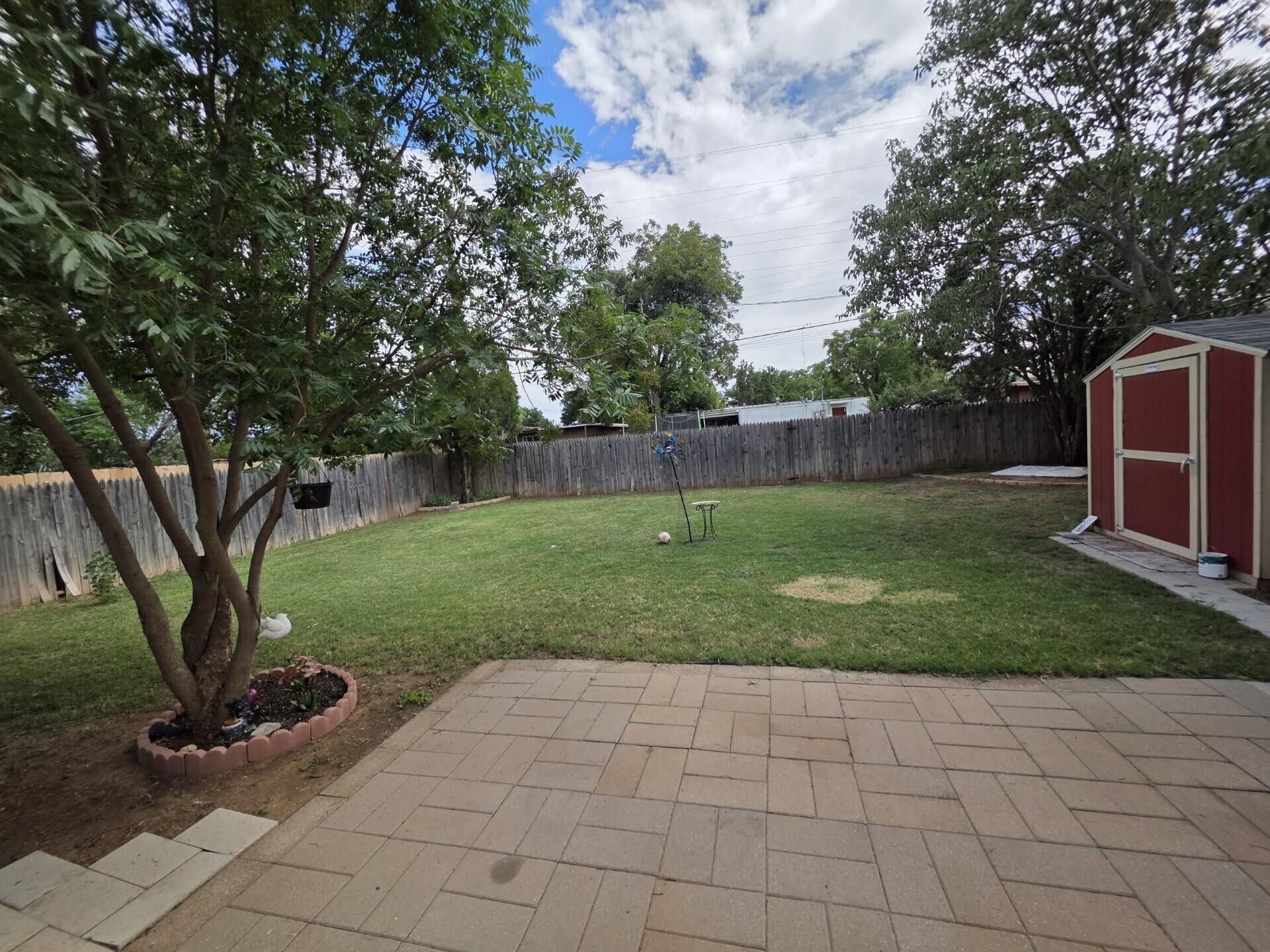 2313 47th Street Lubbock, TX 79412 - Photo 15 of 17 a view of a backyard with large trees