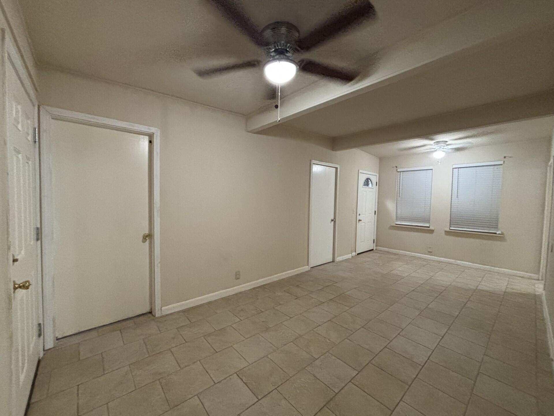 2313 47th Street Lubbock, TX 79412 - Photo 3 of 17 en empty room with fan and entryway