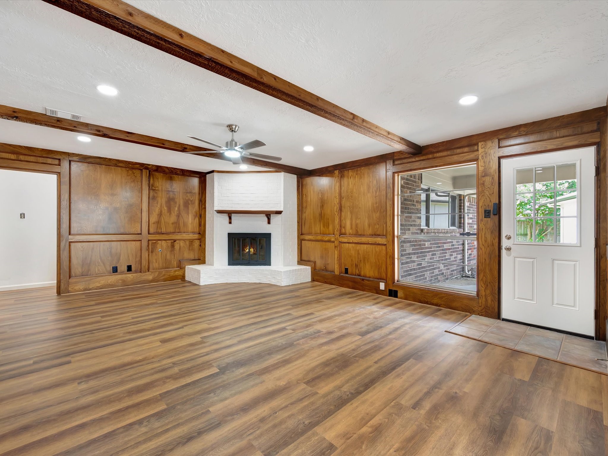 10340 Rocky Hollow Road La Porte, TX 77571 - Photo 17 of 38 This family room features gorgeous wood walls and beams, complemented by a cozy wood-burning fireplace.