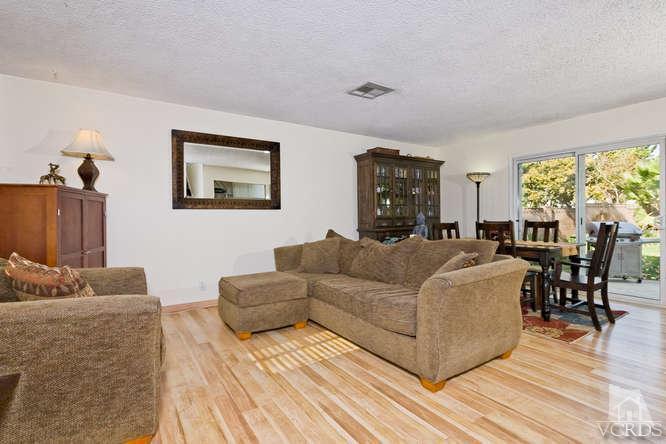 2973 Fitzgerald Road Simi Valley, CA 93065 - Photo 4 of 19 a living room with couches a large window and a dining table