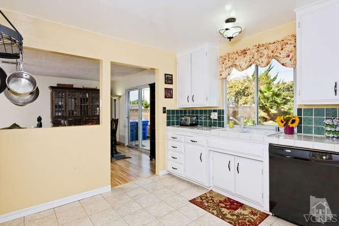 2973 Fitzgerald Road Simi Valley, CA 93065 - Photo 7 of 19 a kitchen with stainless steel appliances a white stove top oven and a refrigerator