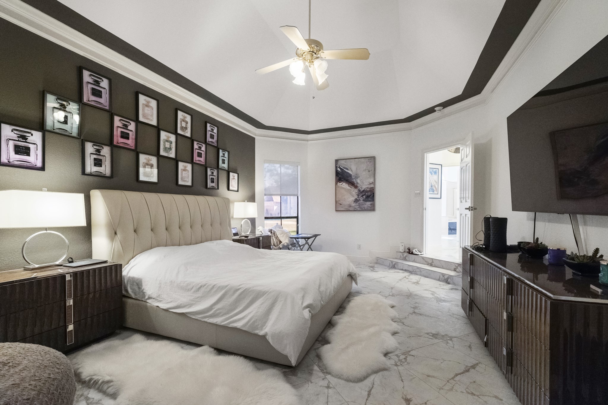 5107 Waterbeck Street Fulshear, TX 77441 - Photo 10 of 30 a bedroom with a bed a mirror and furniture