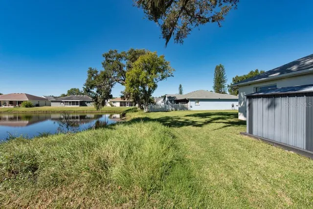 a view of a house with swimming pool and a yard