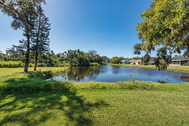 a view of a lake with houses in the back