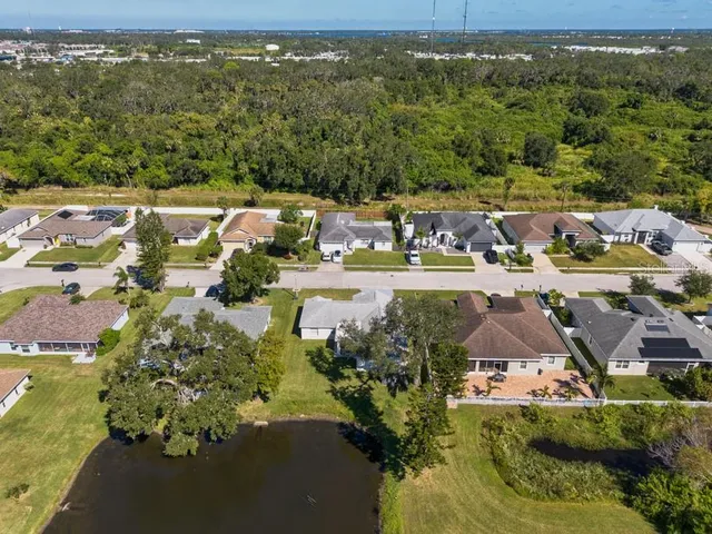 an aerial view of a house with a yard