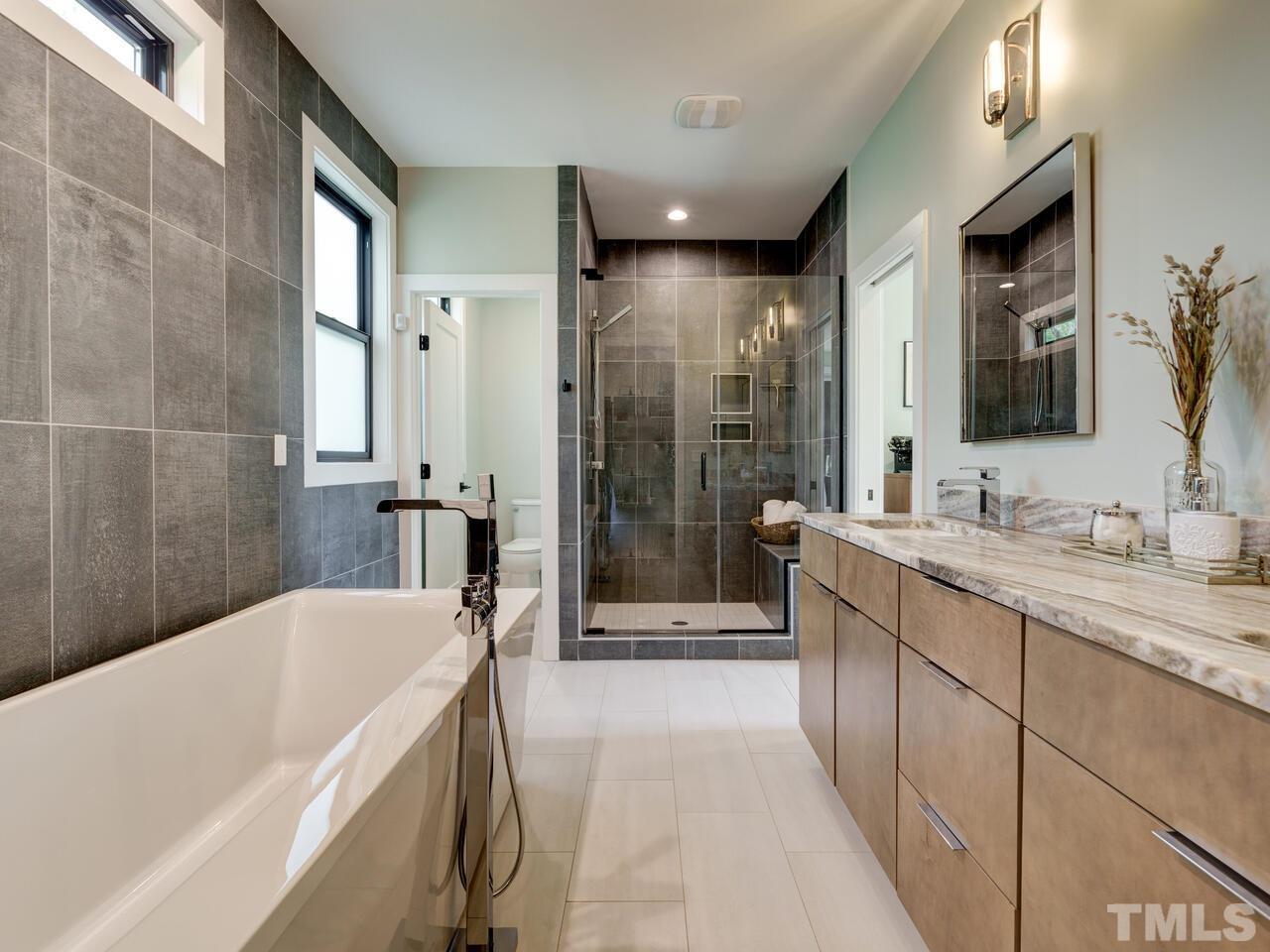 220 Hargrove Street Durham, NC 27701 - Photo 40 of 76 a bathroom with a granite countertop tub sink shower and mirror