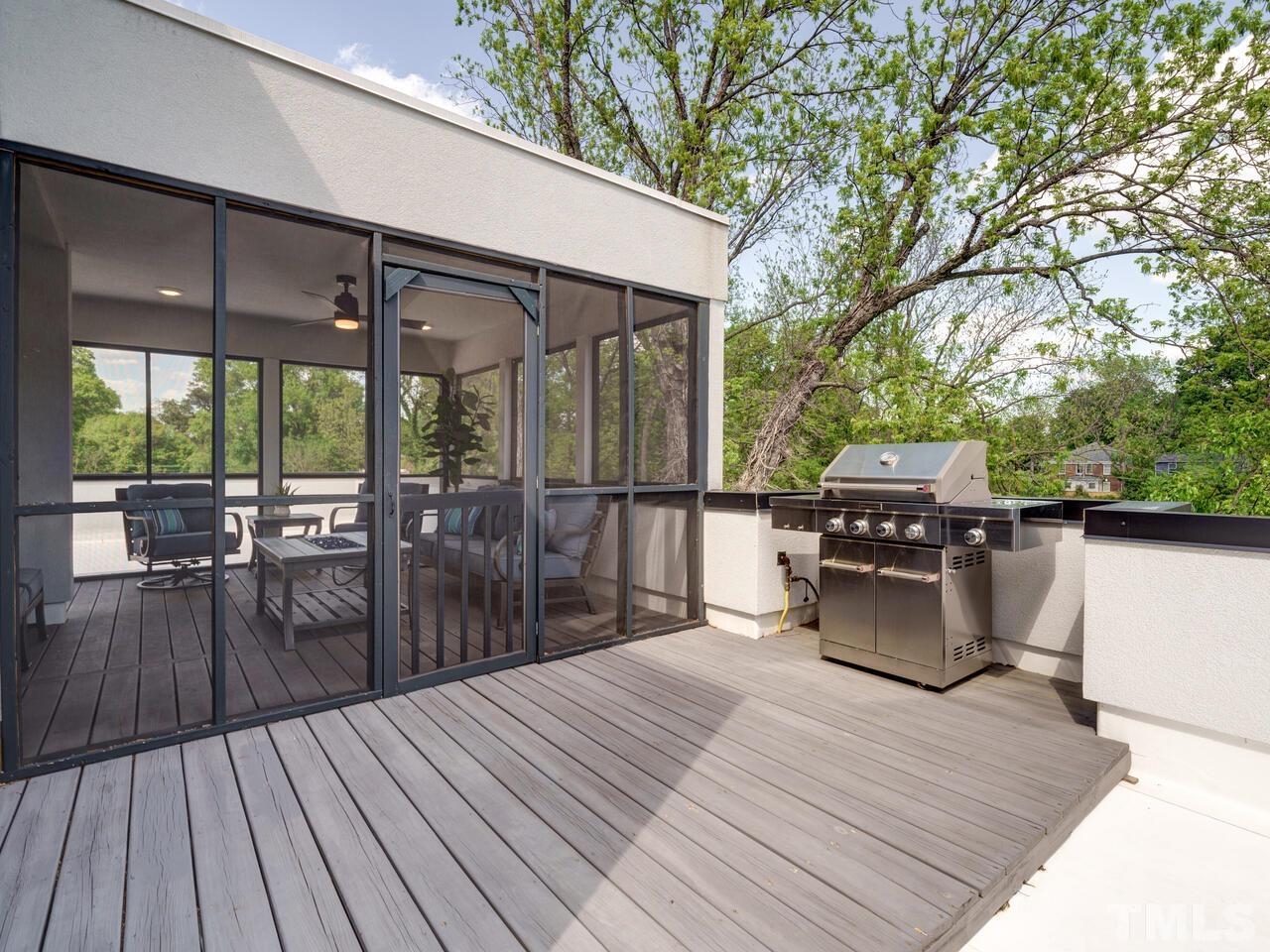 220 Hargrove Street Durham, NC 27701 - Photo 43 of 76 a view of a patio with dining table and chairs with wooden floor and fence