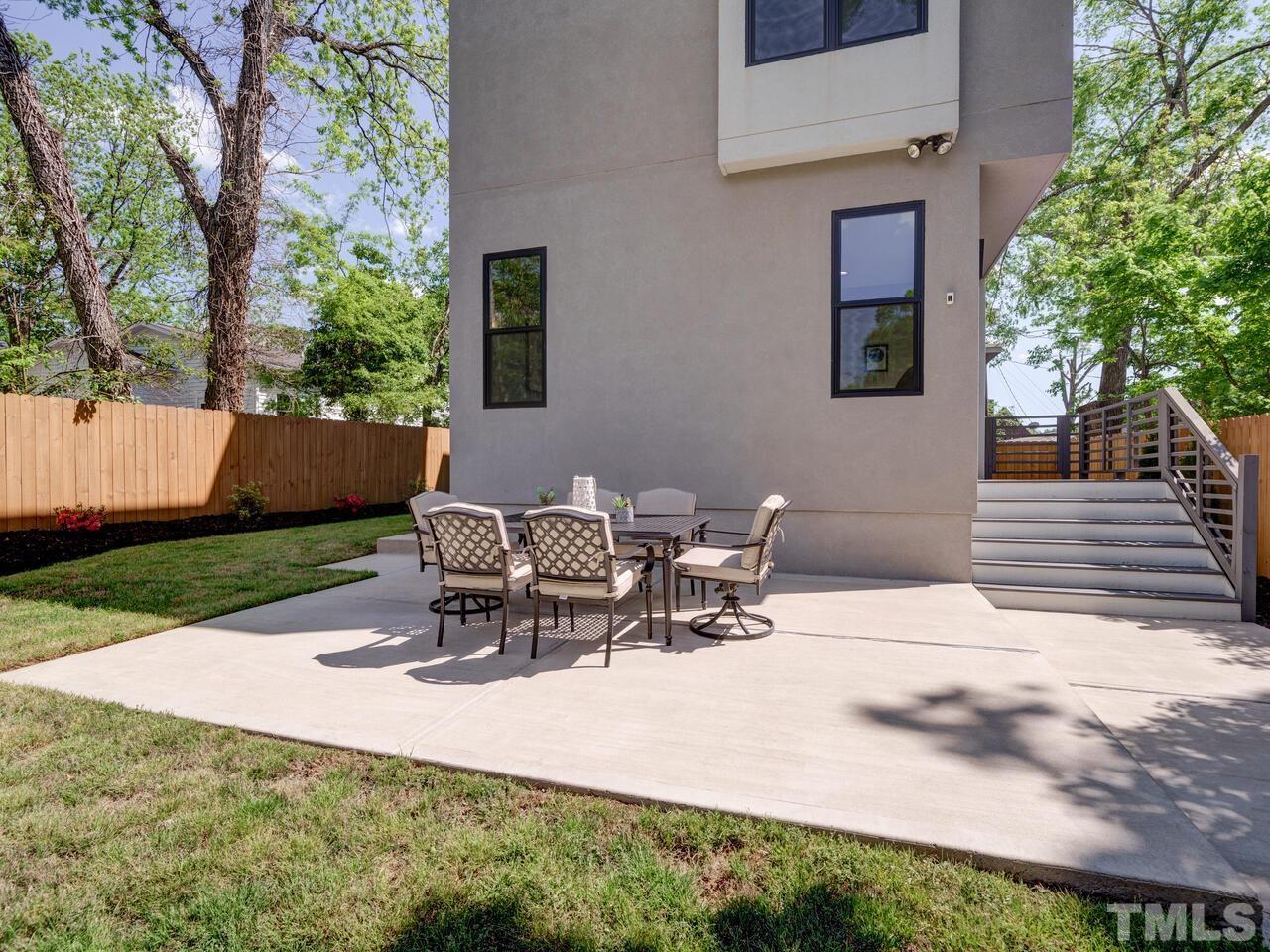 220 Hargrove Street Durham, NC 27701 - Photo 60 of 76 a view of a backyard with table and chairs and a yard