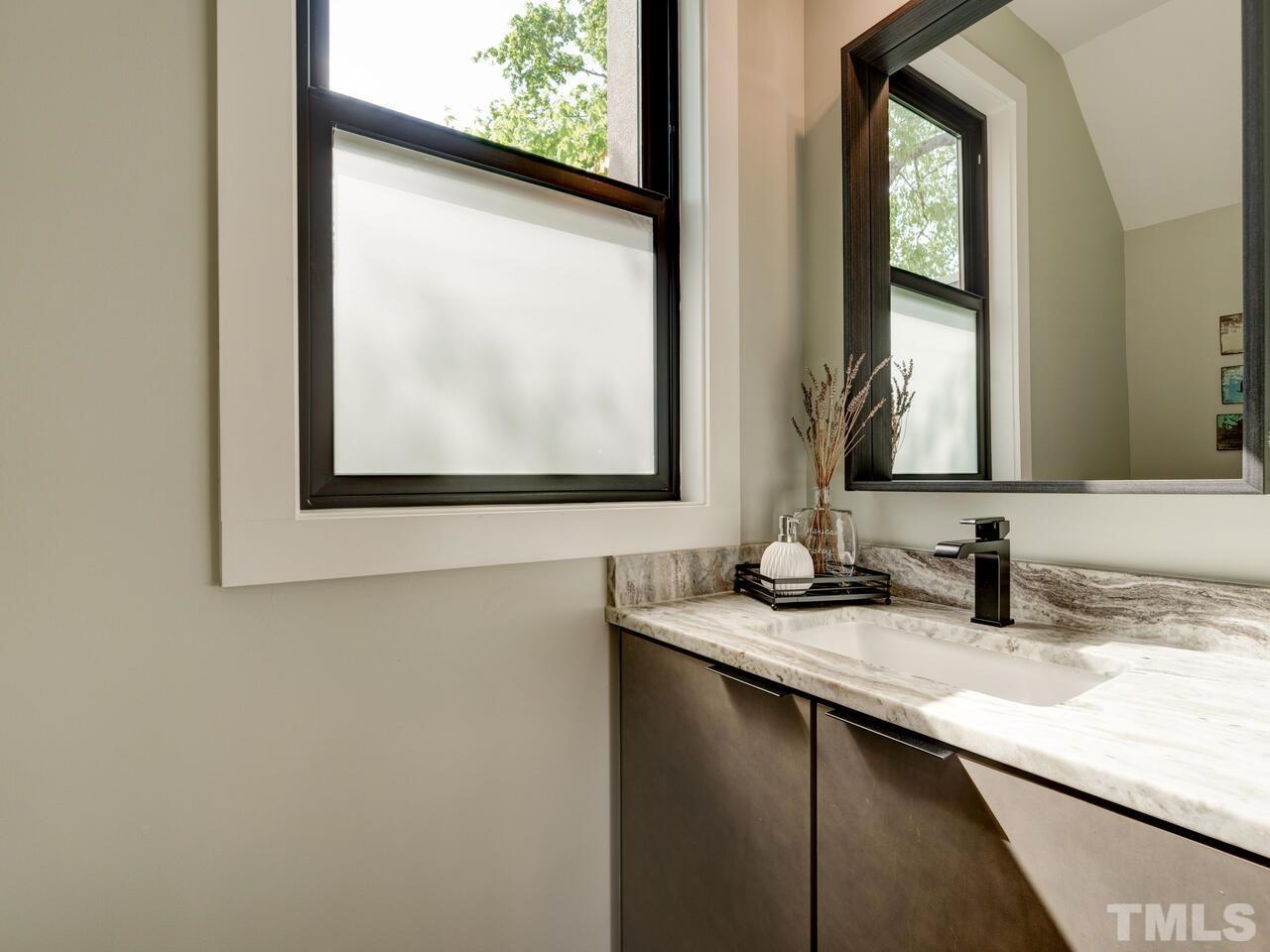 220 Hargrove Street Durham, NC 27701 - Photo 7 of 76 a bathroom with a granite countertop sink and a mirror