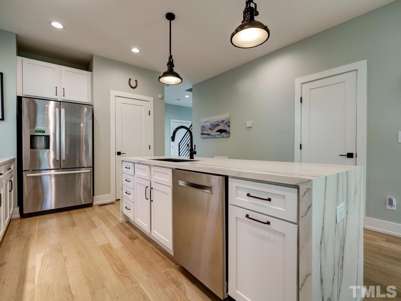 220 Hargrove Street Durham, NC 27701 - Photo 9 of 76 a kitchen with cabinets a sink and stainless steel appliances