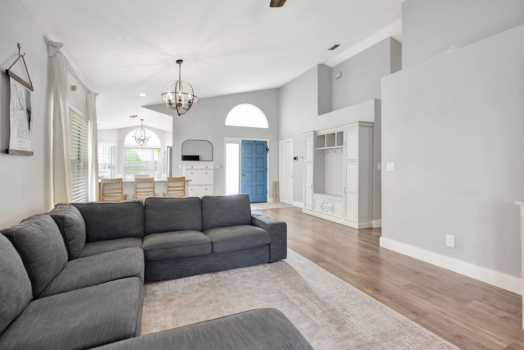 6247 Ungerer Street Jupiter, FL 33458 - Photo 11 of 36 a living room with furniture and a chandelier