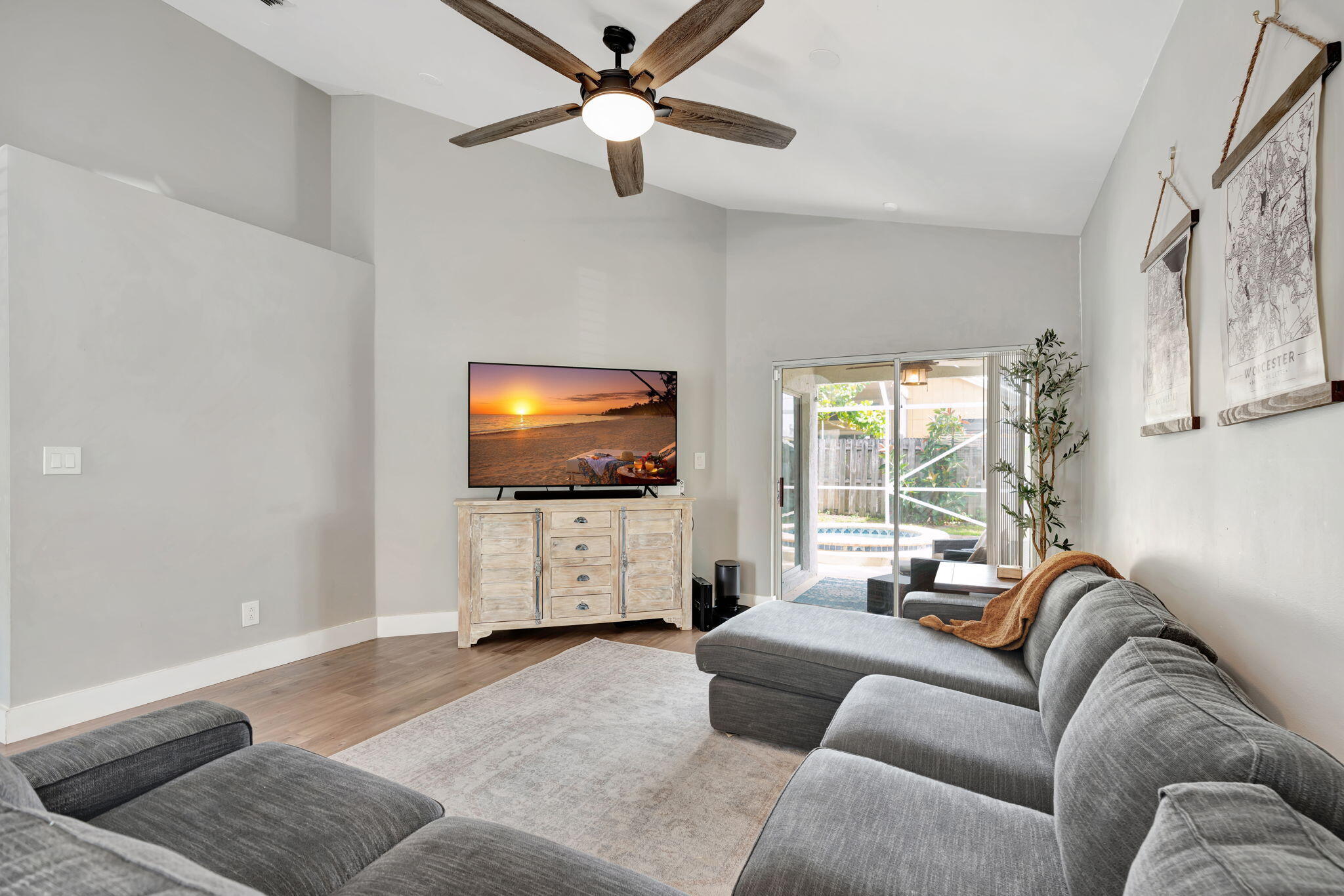 6247 Ungerer Street Jupiter, FL 33458 - Photo 12 of 36 a living room with furniture and a flat screen tv