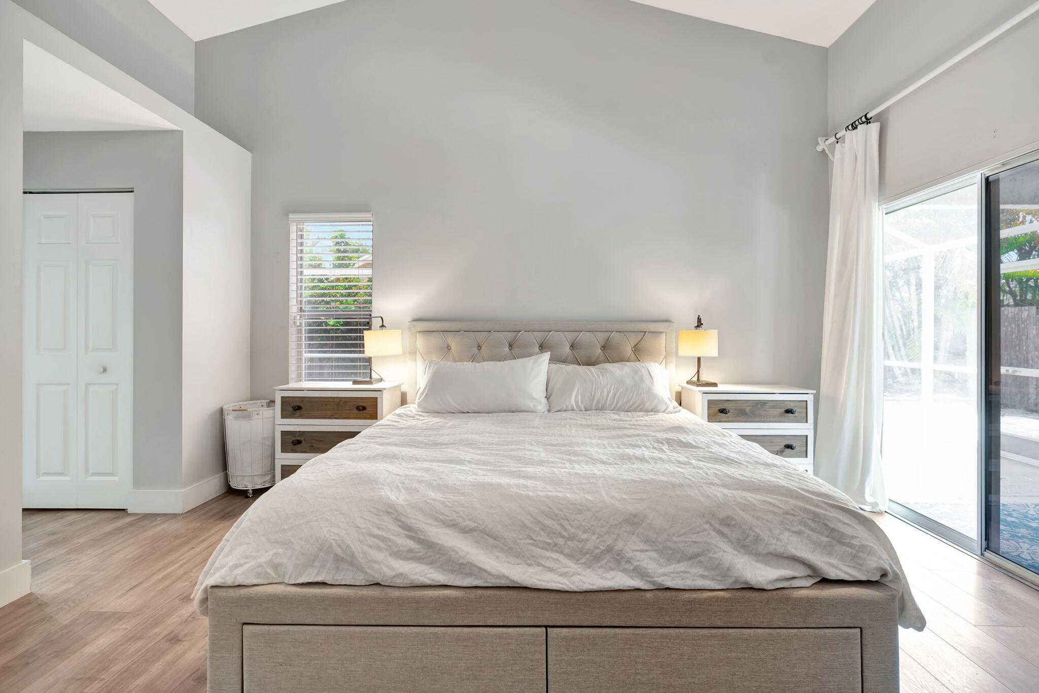 6247 Ungerer Street Jupiter, FL 33458 - Photo 27 of 36 a bedroom with a large bed and wooden floor