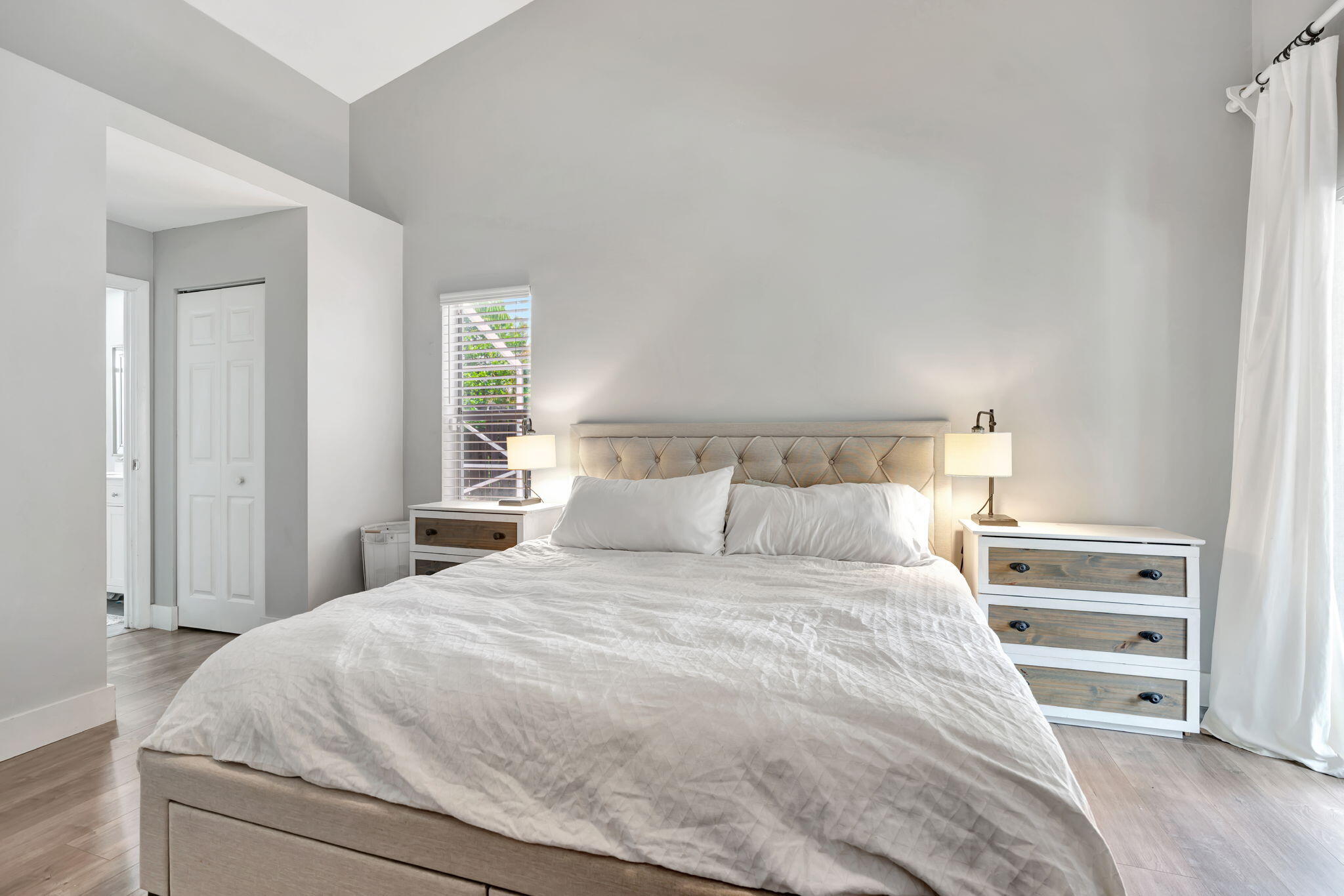6247 Ungerer Street Jupiter, FL 33458 - Photo 28 of 36 a bedroom with a large bed and wooden floor