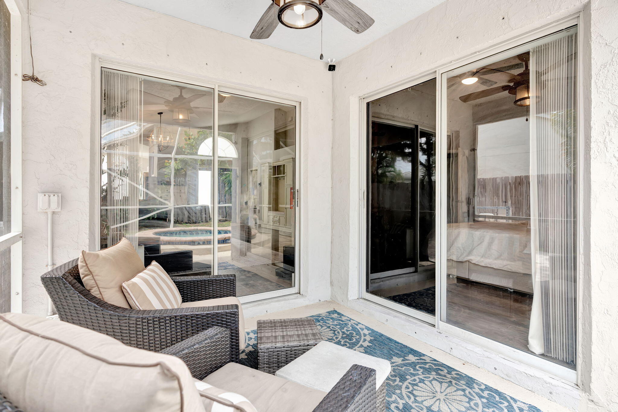6247 Ungerer Street Jupiter, FL 33458 - Photo 31 of 36 a living room with furniture and a floor to ceiling window