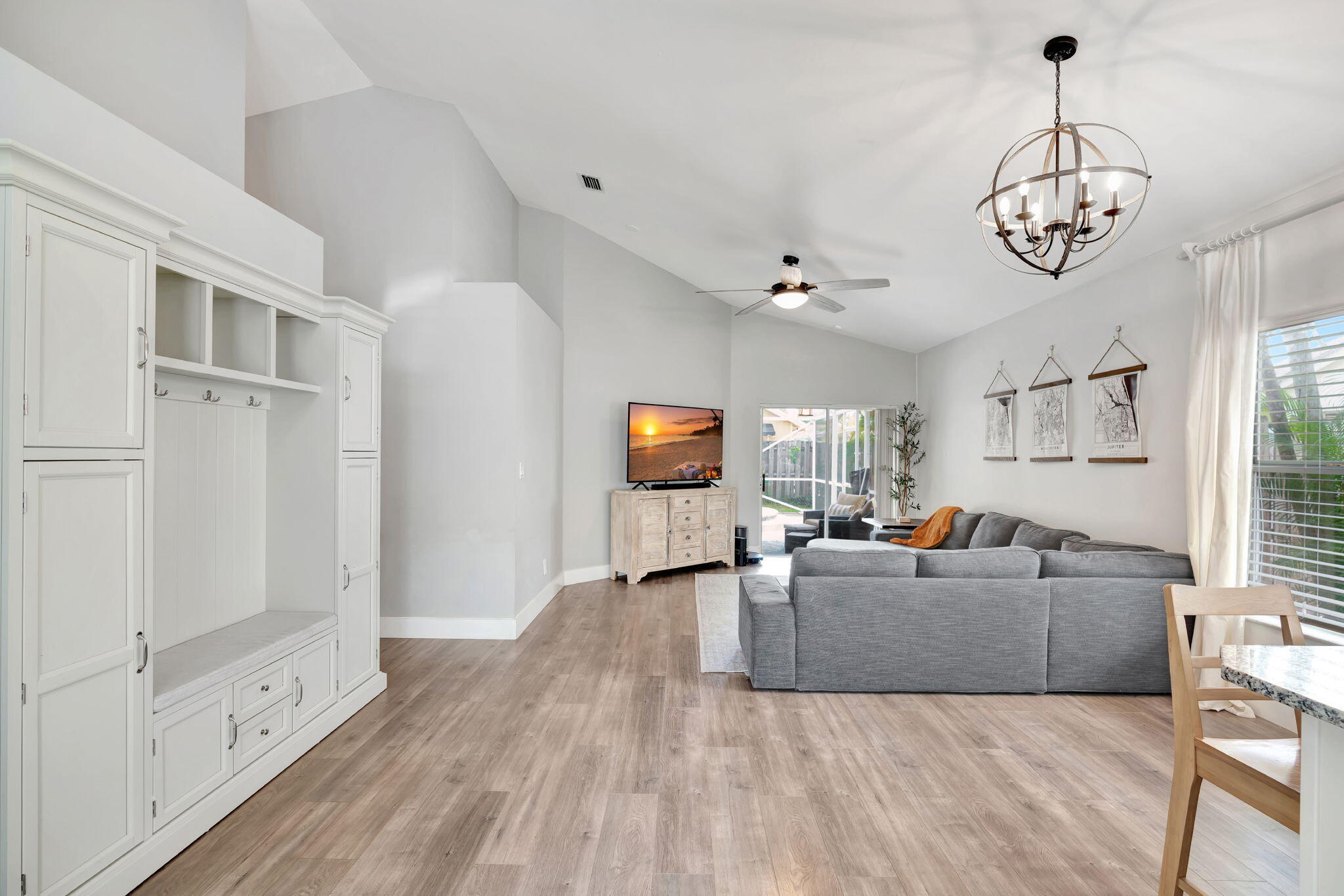 6247 Ungerer Street Jupiter, FL 33458 - Photo 5 of 36 a living room with furniture and a chandelier