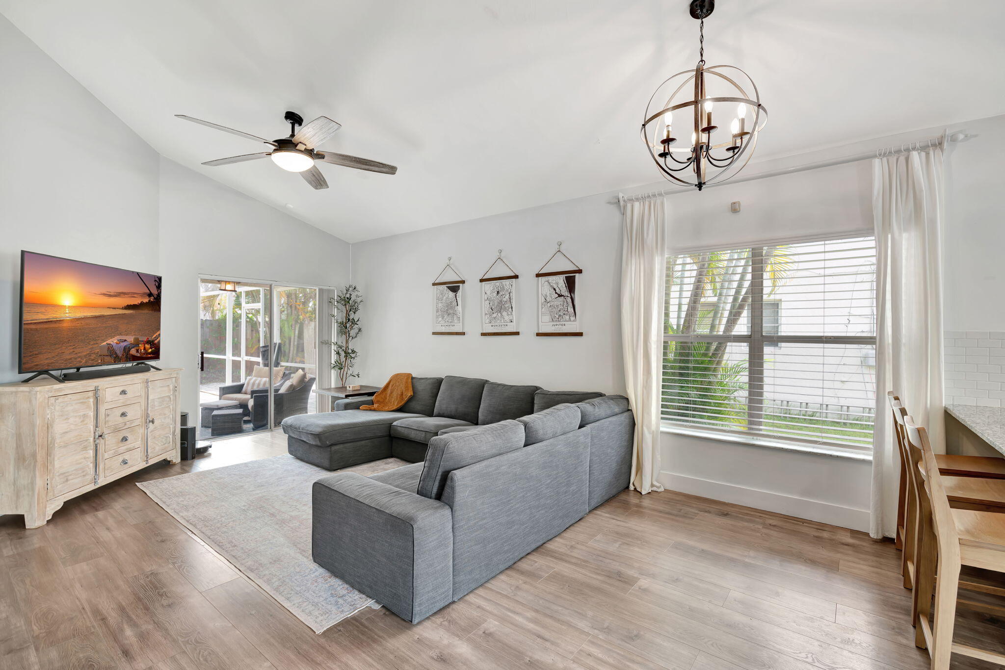 6247 Ungerer Street Jupiter, FL 33458 - Photo 7 of 36 a living room with furniture a flat screen tv and a window