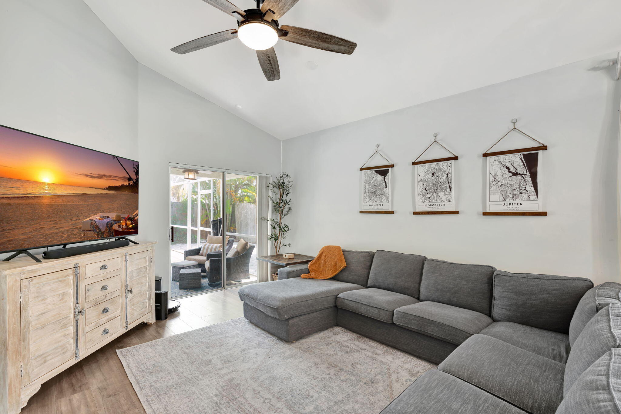 6247 Ungerer Street Jupiter, FL 33458 - Photo 8 of 36 a living room with furniture and a flat screen tv