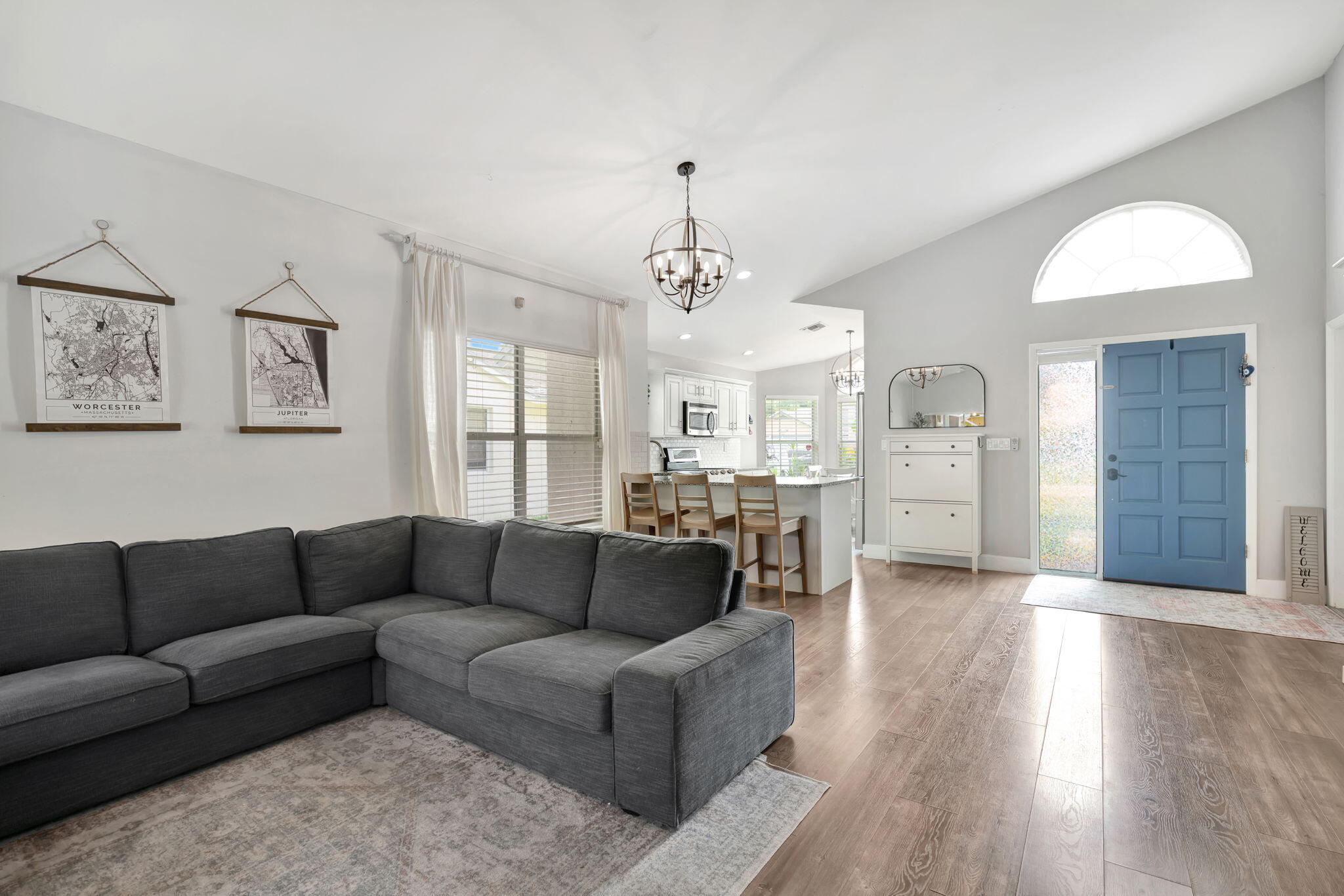 6247 Ungerer Street Jupiter, FL 33458 - Photo 9 of 36 a living room with furniture and a chandelier