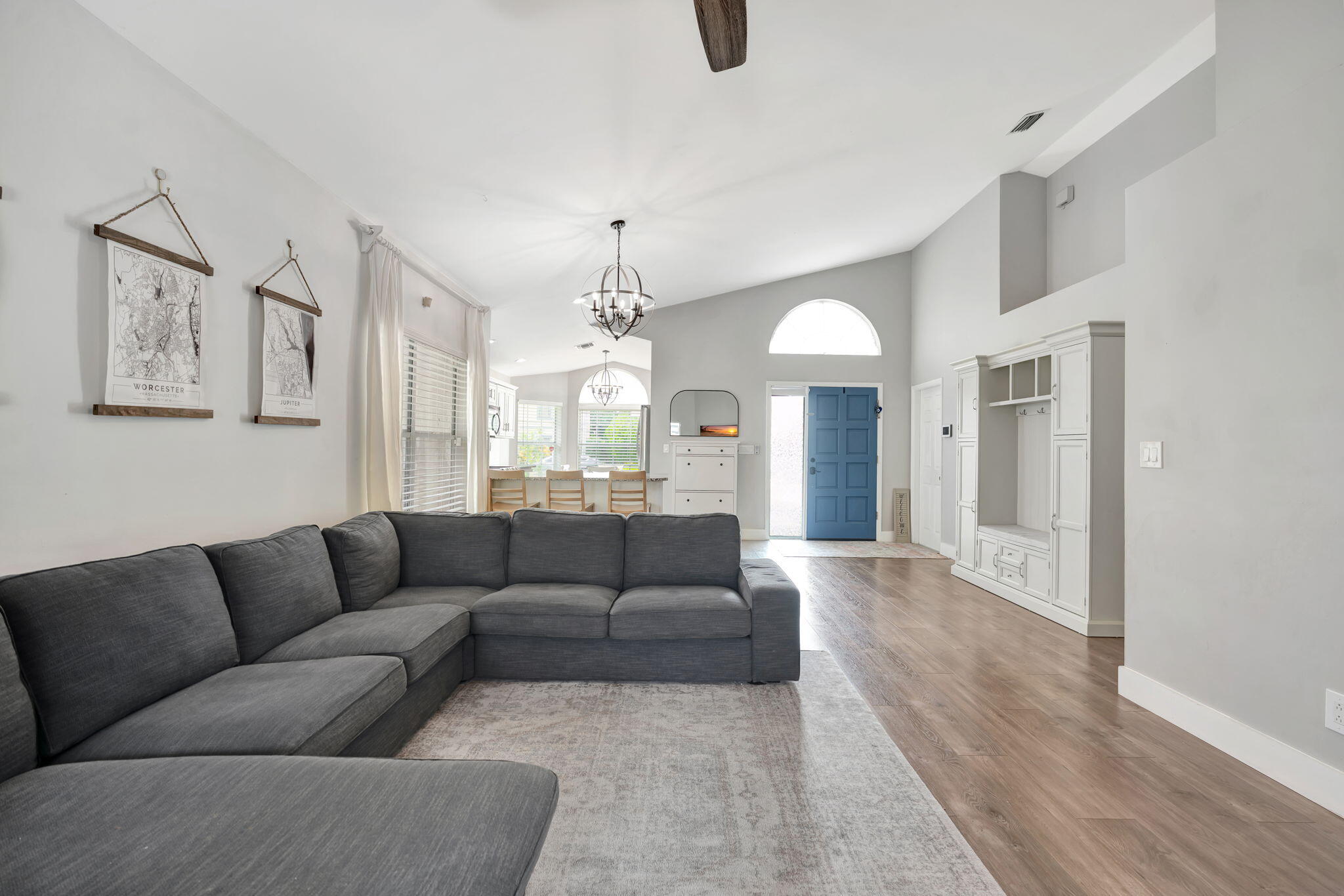 6247 Ungerer Street Jupiter, FL 33458 - Photo 10 of 36 a living room with furniture and a chandelier