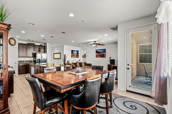 a view of a dining room and livingroom with furniture wooden floor and a rug