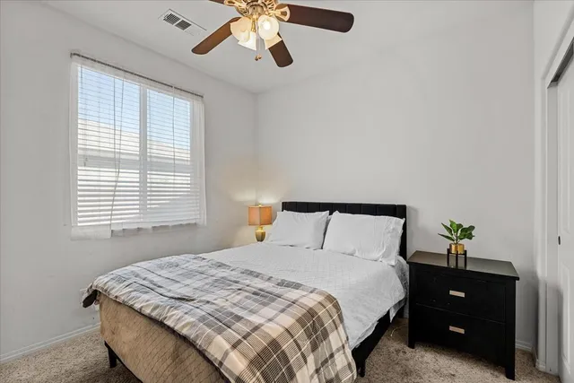 a bathroom with a double vanity sink a toilet and a large mirror