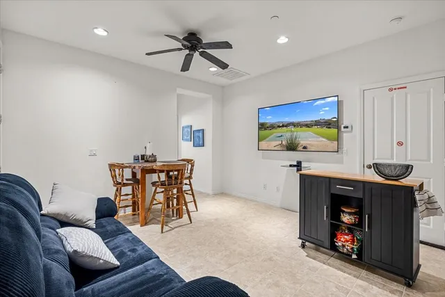 a bedroom with a bed a computer on a desk and chair